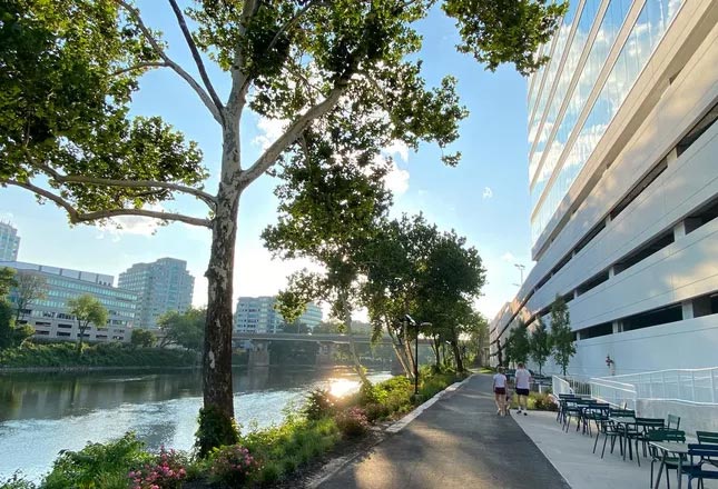 A riverfront walking path is popular for walking meetings, fitness and rejuvenation. 